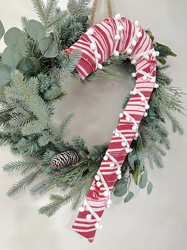 candy cane with pom poms on wreath