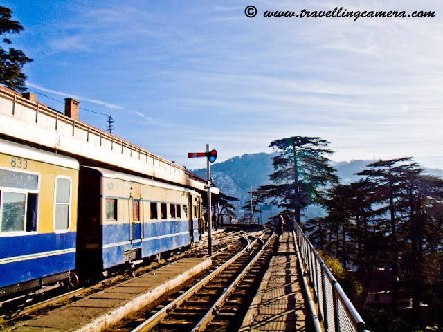 Travelling Camera @ Shimla Railway Station, Himachal Pradesh (Waiting for Himalyan Queen for back journey to Kalka): POSTED BY VJ SHARMA AT www.travellingcamera.com : Shimla Railway Station is under the administrative control of Northern Railways. It is located about 3.25 kilometers from Chotta Shimla. It has a narrow gauge railway line linked to Kalka (92 kilometers) on which the toy trains run. The journey on the toy train offers amazing experience to the travellers. Shivalik Express, Shimla Mail and Kalka Shimla Rail Motor Car (special train) pass through this station. Computerized reservation facility is provided...Himalyan Queen Waiting @ Shimla Railway Station...Don't miss the Doordarshan Tower on hill-top in this Photograph...A view of other side of Shimla.. Probably Chhota Shimla...A few minutes walk from the station is Shimla Bus Station. Just 2.5 kilometers from the railway-station is the Mall Road which is main attraction among Tourists in Shimla. The nearest airport is Shimla Airport at Jubbalhatti which is around 25 kilometers from Railway Station...A View of deep valley from Himalyan Queen @ Shimla Railway Station.Its time to depart from Shimal and forget this freshness...Main Entry to Shimla Railway Station...The route offers a panoramic views of the amazing Himalayas from the Sivalik foot hills at Kalka to several important points such as Dharampur, Solan, Kandaghat, Taradevi, Barog, Salogra, Summerhill and Shimla at an altitude of 2100 meters...
