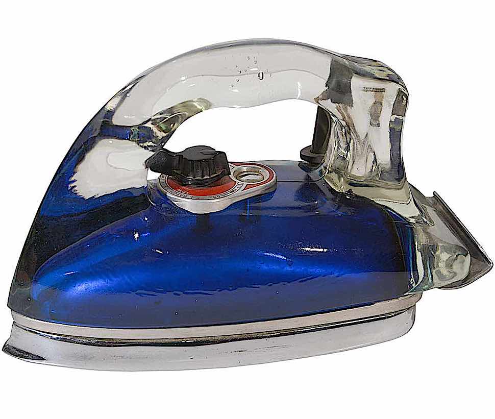 a 1940s Silver Streak Pyrex glass laundry iron in a color photograph