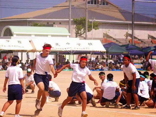 children passing baton in relay race