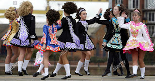 A group of preteen girls in Irish dance solo dresses performing a kay-lee dance. Used here as a placeholder.