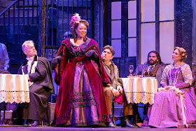 IN REVIEW: (from left to right) baritone ROBERT WELLS as Alcindoro, soprano DIANA THOMPSON-BREWER as Musetta, baritone DAVID PERSHALL as Marcello, tenor ARNOLD LIVINGSTON GEIS as Rodolfo, and soprano SUZANNE KANTORSKI as Mimì in Greensboro Opera's November 2022 production of Giacomo Puccini's LA BOHÈME [Photograph by VanderVeen Photographers, © by Greensboro Opera]