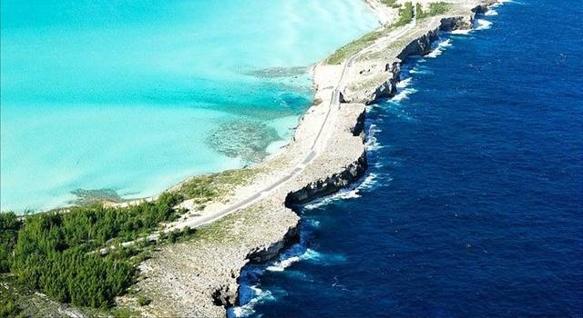 Eleuthera is one of several islands that lies within the archipelago in The Bahamas, about 80 km east of the capital city Nassau. It is long – about 180 km – and thin - only about 1.6 km wide in places. The light blue waters of the shallow Caribbean Sea on one side of the island stand out in stark contrast to the deep blue of the Atlantic Ocean thousands of feet in depth. One of the best places to see this extraordinary juxtaposition is at the Glass Window Bridge.