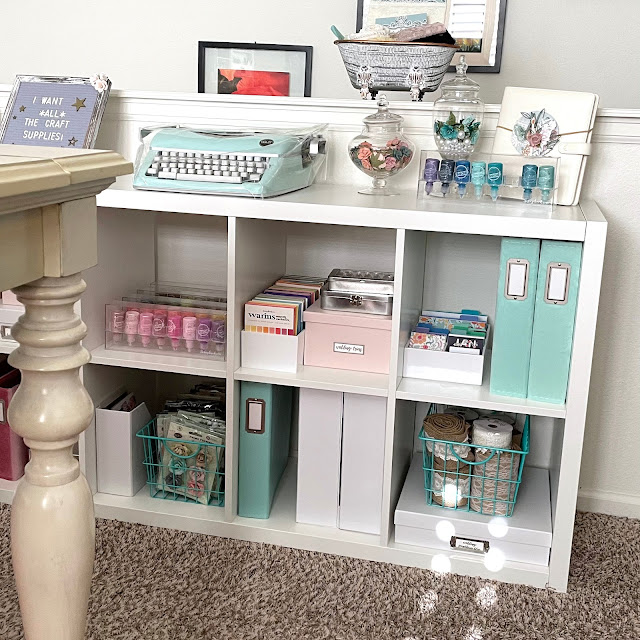 IKEA Kallax Shelves, Container Store blush boxes and aqua baskets, Tim Holtz tins, Scrapbook.com albums
