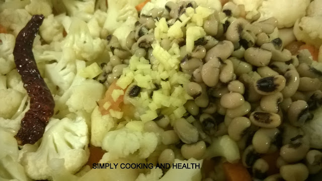 Adding boiled beans,garlic and ginger