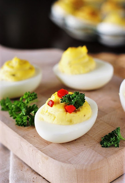 Deviled Eggs Garnished with Parsley and Pimento Image