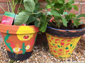 Painting strawberry planters at the garden centre