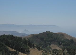 Misty view of Morro Rock and the Pacific Ocean from Highway 46 above Cambria, California