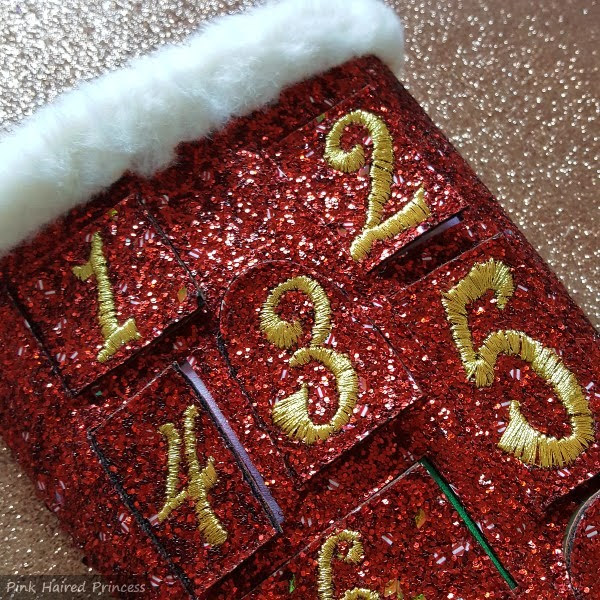 close up of red glitter advent calendar boots with furry white trim