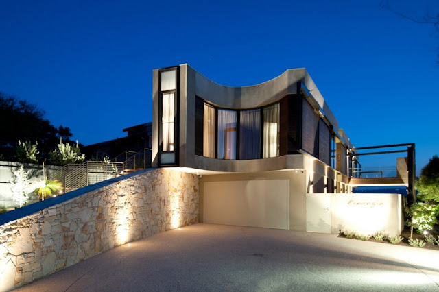 Lit up modern home from the driveway 