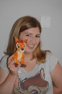 Meagan holding a small Bambi stuffed toy while wearing her grey Bambi t shirt