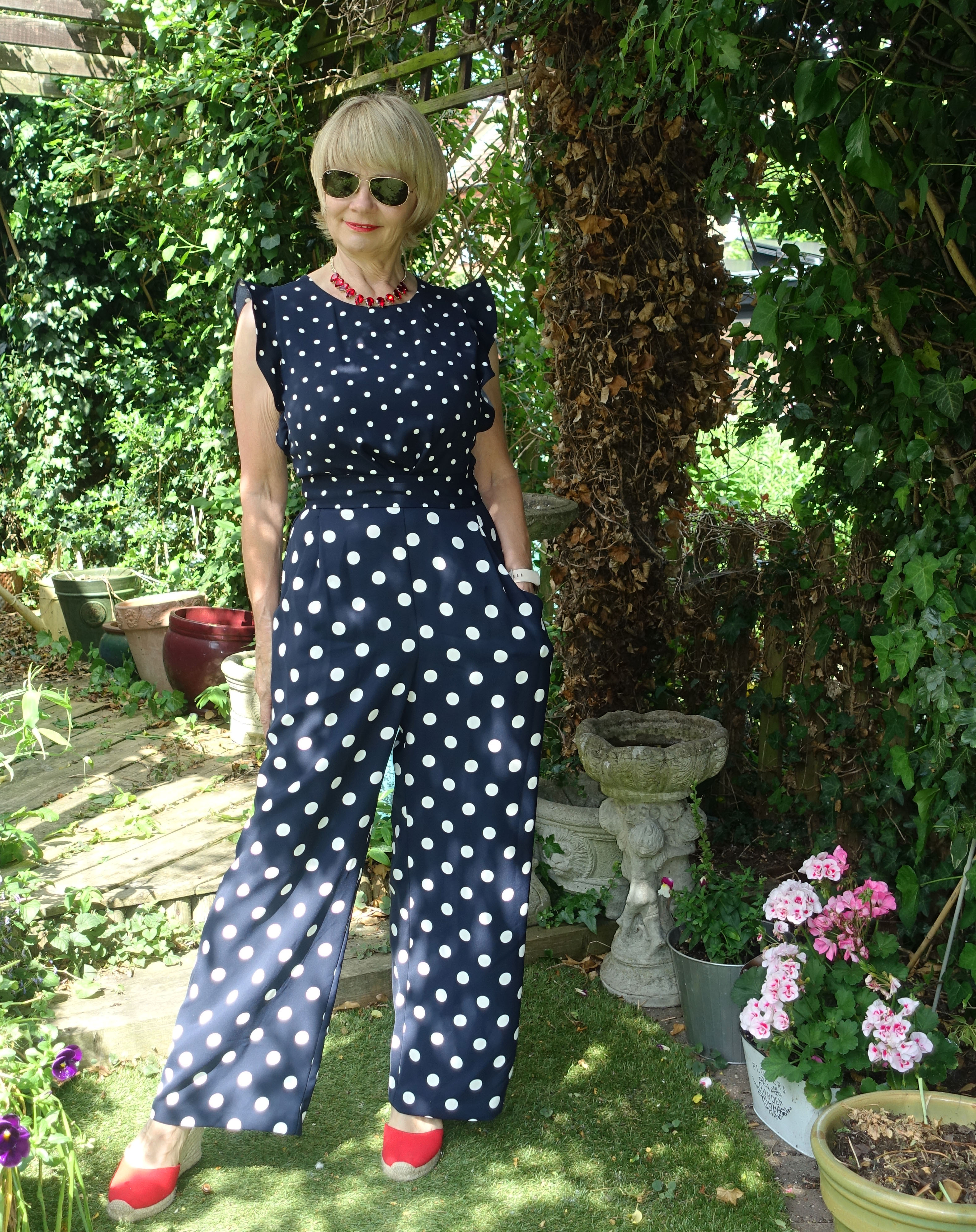 Red accessories add a little sizzle to Is This Mutton blogger Gail Hanlon's navy and white polka dot jumpsuit