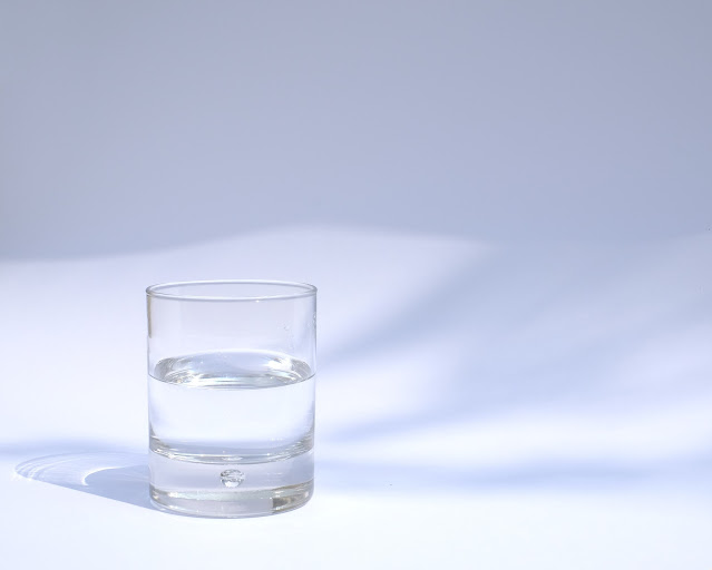 Glass of water on white background: Photo by manu schwendener on Unsplash