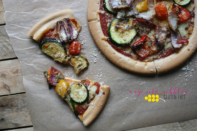 She roasts the veggies first and then adds them to the pizza crust before baking again. Recipe available on Anyonita Nibbles Gluten Free