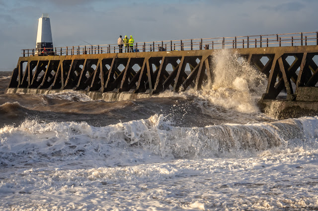 Photo of Phil chatting to two fishermen on the pier