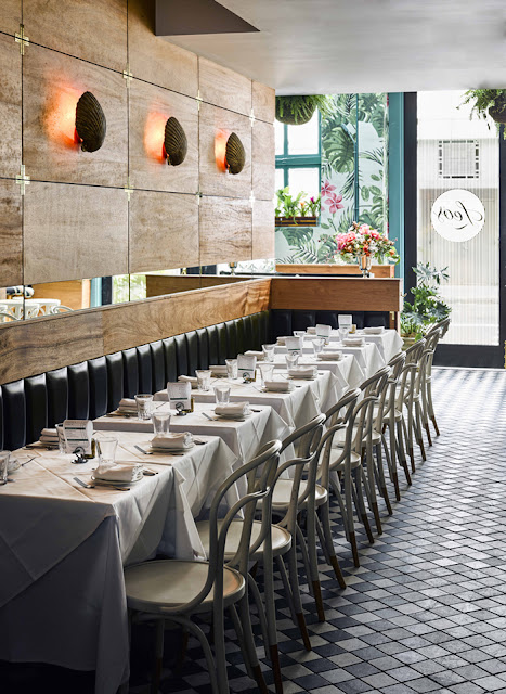 Chic restaurant dining area diamond tiles booth by Ken Fulk