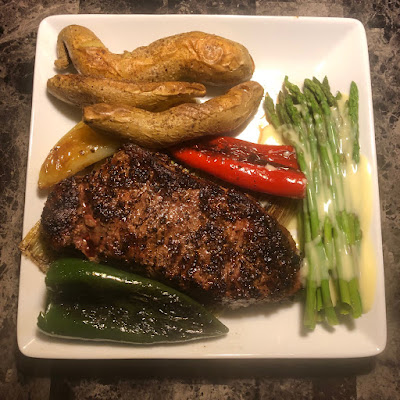 Rare grilled New York strip, oven roasted white sweet potatoes, grilled leeks and peppers and steamed asparagus with Hollandaise