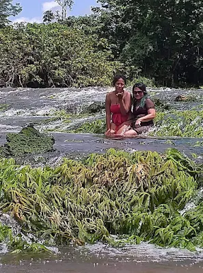 " Shachem Lieuw and friend at Tap a watra falls in Sipaliwini Suriname"