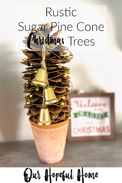 rustic sugar pine cone Christmas tree decorated with gold bells