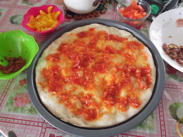 Pizza base with tomato puree soread