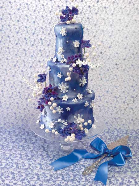 Metallic purple three tier wedding cake with white and purple flowers