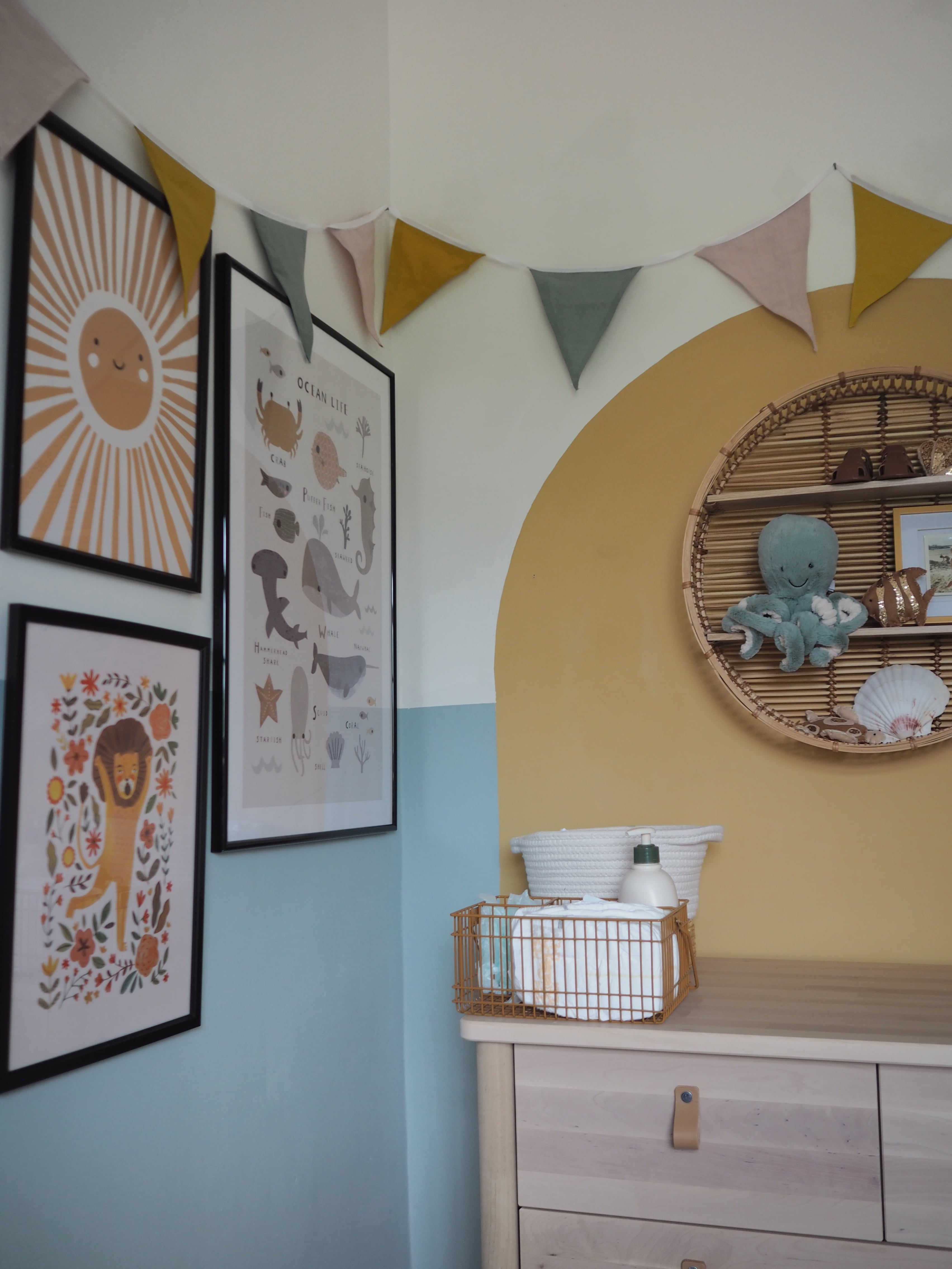 Under the sea ocean themed baby nursery inspiration budget. Gender neutral child's bedroom in blue and mustard yellow with half-painted colour block