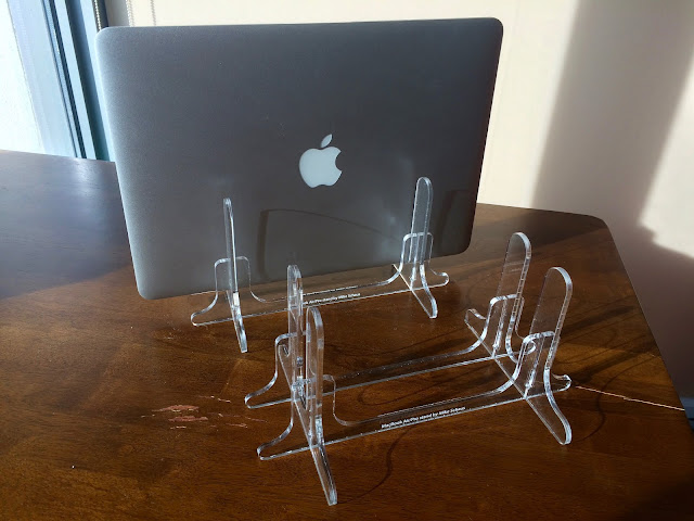 The two copies of the laptop stand I cut out of acrylic