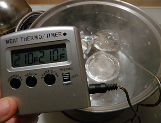 Digital Thermometer in Water Bath Reads Steady at 210 Degrees