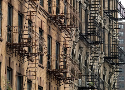 Fire escapes on brownstone New York City