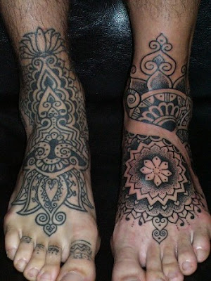 Heavy tribal foot tattoo idea for menHeart and dagger foot tattoo for guys