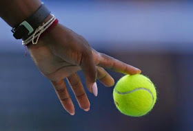 Serena Williams bounces a ball as she serves to Caroline Wozniacki of Denmark during their women's singles finals match at the 2014 U.S. Open tennis tournament in New York, September 7, 2014. REUTERS/Adam Hunger