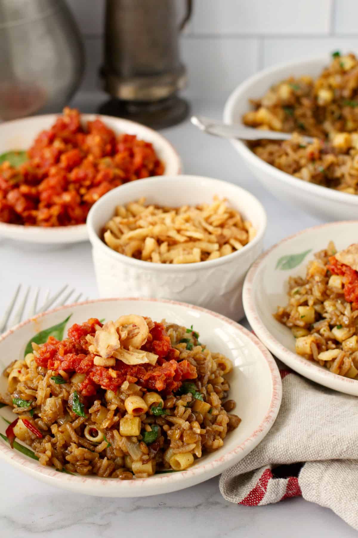 Egyptian Kushari with bowls of topping.