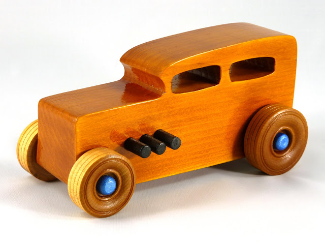 Left Front - Wooden Toy Car - Hot Rod Freaky Ford - 32 Sedan - Pine - Amber Shellac - Black Pipes - Metallic Blue Hubs