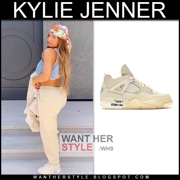 Kylie Jenner in beige sweatpants, beige sneakers with blue bag.