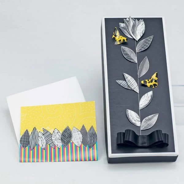 handmade card and paper covered box with leaves cut from patterned paper