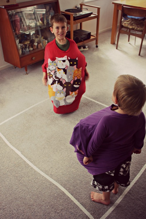 Two boys getting ready to sumo wrestle
