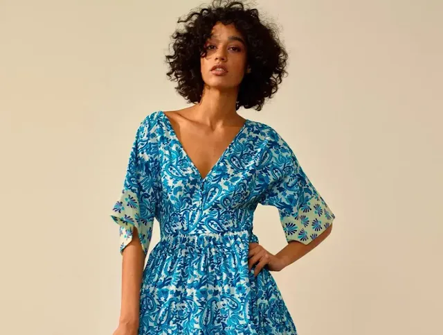 A latin girl wearing a blue summer dress