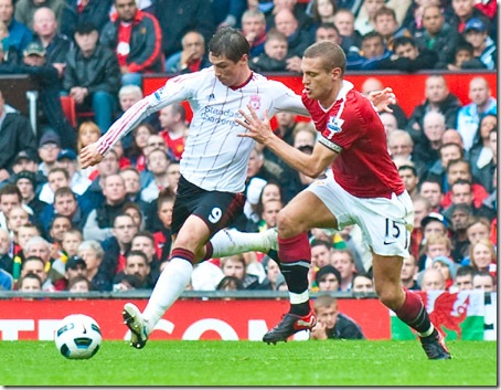 MANCHESTER, ENGLAND - Sunday, September 19, 2010: Liverpool's Fernando Torres and Manchester United's Nemanja Vidic during the Premiership match at Old Trafford. (Photo by David Rawcliffe/Propaganda)