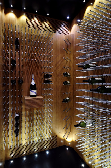 Picture of vine bottles on the walls in the vine room