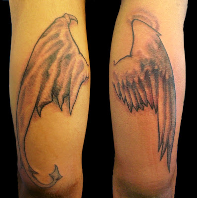 Tattoo: Custom "evil" and "good" wings. Location: Back of upper arm (Left is Tattoo: Custom "evil" and "good" wings. Location: Back of upper arm (Left is