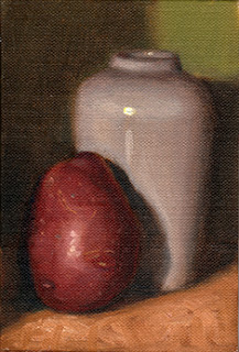 Oil painting of a red-skinned potato beside a white porcelain vase.