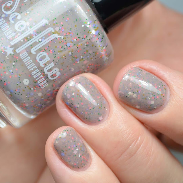 nude nail polish with 60's inspired glitter mix swatch