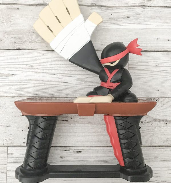 Unboxed toy ninja game with a large over sized hand with a chop action