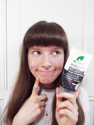 Pointing to acne prone skin and holding up a skincare product for acne