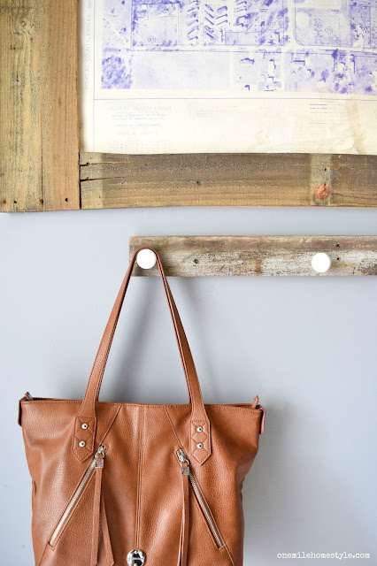 Update your entryway with a DIY reclaimed wood organizer, and large statement art to add a personal touch to the space.