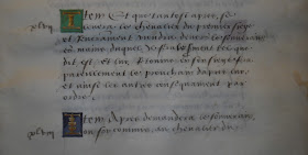 A page of handwritten text with colored initials.
