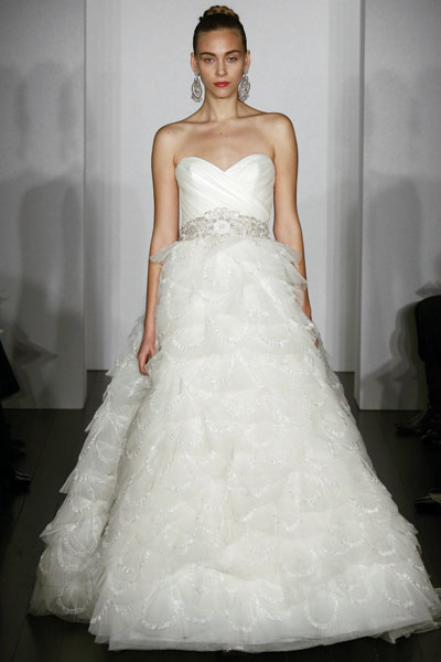 Tiered full skirt is adorned with pleated Tulle tiered wedding dress