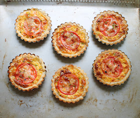 Food Lust People Love: These cheesy grilled corn tartlets boast grilled fresh corn, melty Saint Félicien cheese and a pretty slice of tomato on top, baked up in a flakey puff pastry crust. We ate these little beauties as a main course, alongside salad and green beans, but they would also be perfect for a special tea party or brunch.