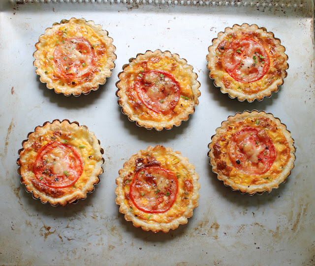 Food Lust People Love: These cheesy grilled corn tartlets boast grilled fresh corn, melty Saint Félicien cheese and a pretty slice of tomato on top, baked up in a flakey puff pastry crust. We ate these little beauties as a main course, alongside salad and green beans, but they would also be perfect for a special tea party or brunch.