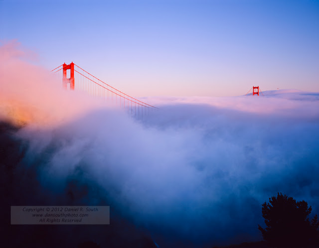 a large format fine art photograph of the golden gate bridge in fog